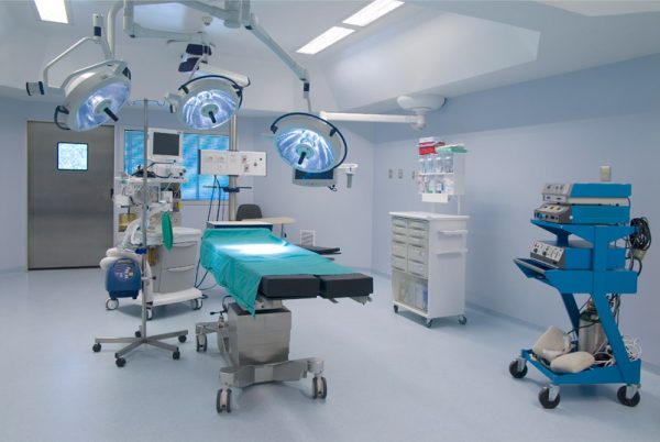 A hospital room with surgical equipment and medical supplies.