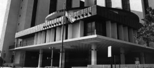 A black and white photo of the front entrance to an office building.